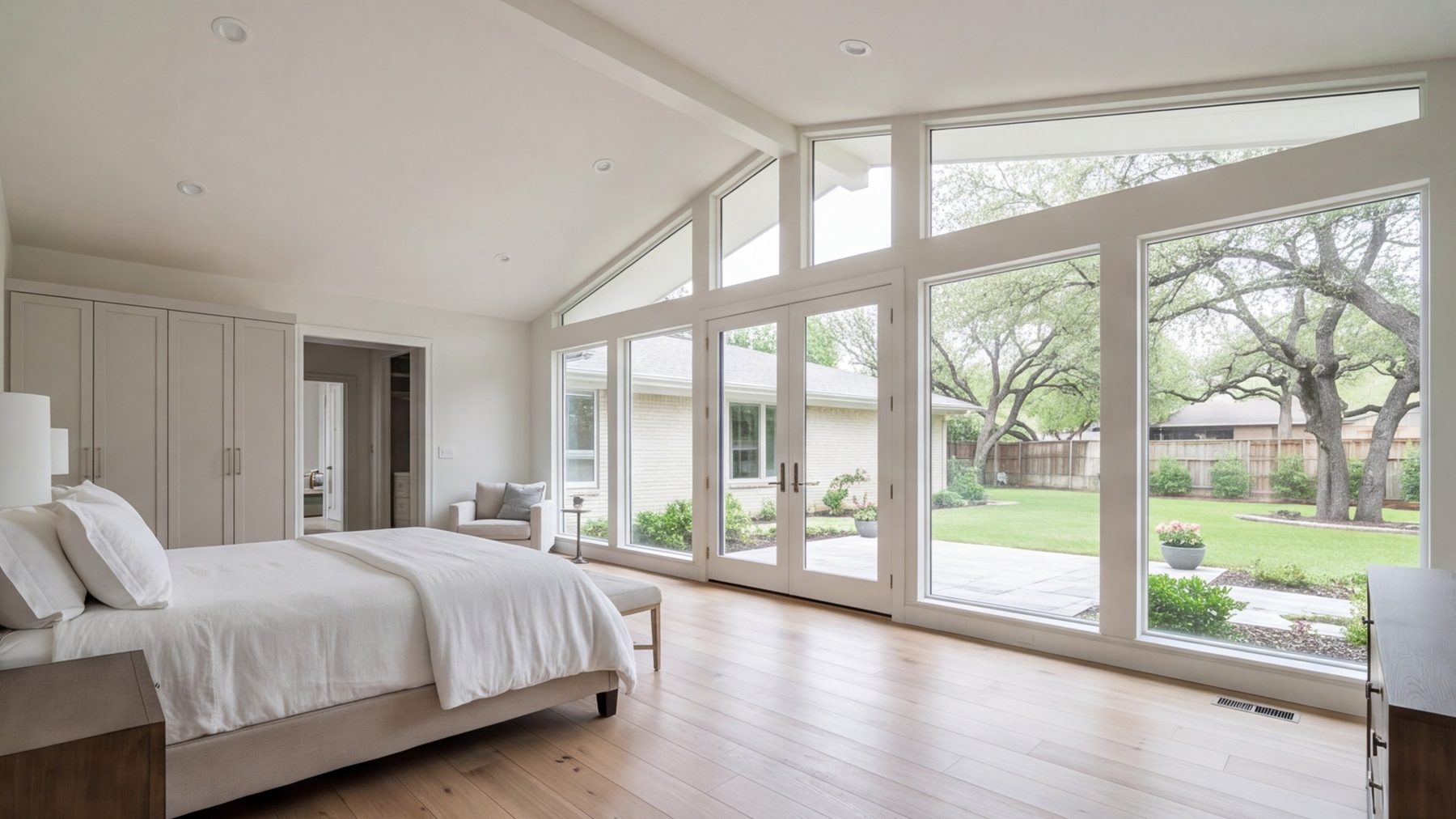 New primary suite addition on a Fort Worth ranch house with tall windows and doors to the back yard